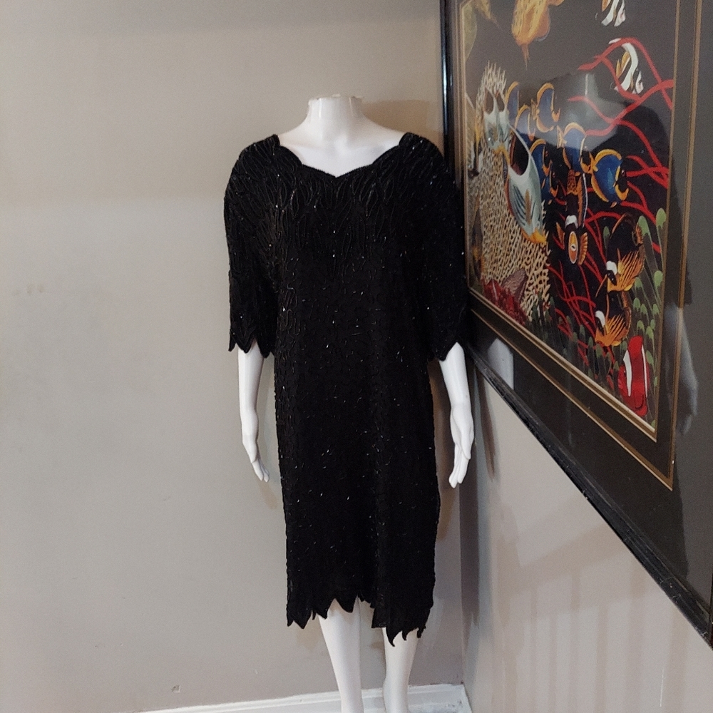 Size 4x knee length Lawrence Kazar black Sequined dress with fancy hem.